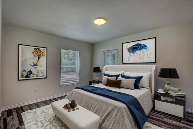 a bedroom with a bed and a painting on the wall