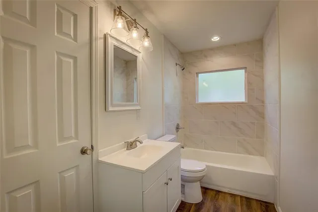 a bathroom with a toilet a sink and a bathtub
