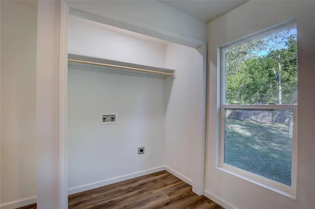 a view of room with window and wooden floor