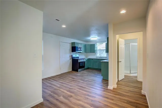 a kitchen with granite countertop a stove and a sink