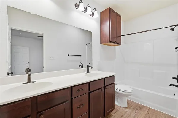 a bathroom with a sink vanity toilet and shower
