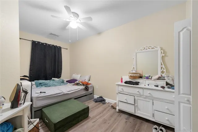 a bedroom that has a bed and a table in it