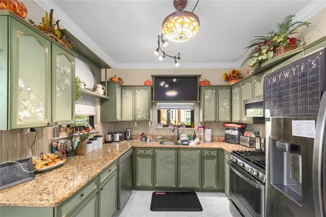 a kitchen with a sink appliances and cabinets