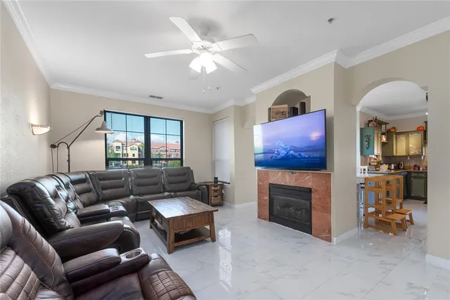 a living room with furniture a fireplace and a flat screen tv