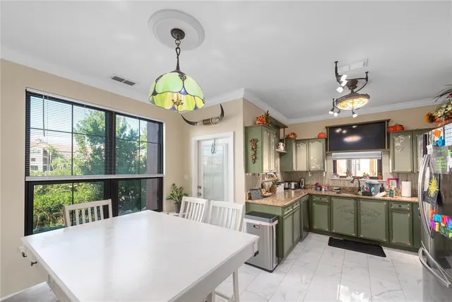 a kitchen with a stove a kitchen island a stove and a view of living room