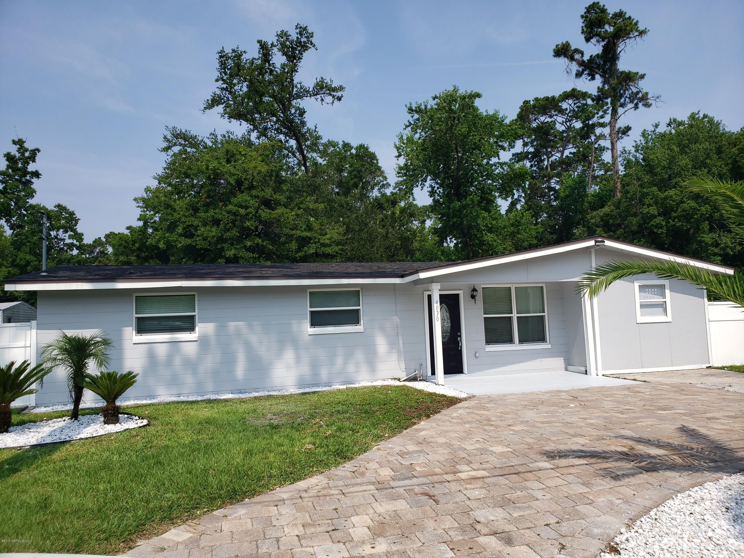 4030 Springwood Road Jacksonville, FL 32207 - Photo 1 of 19 a front view of a house with a garden