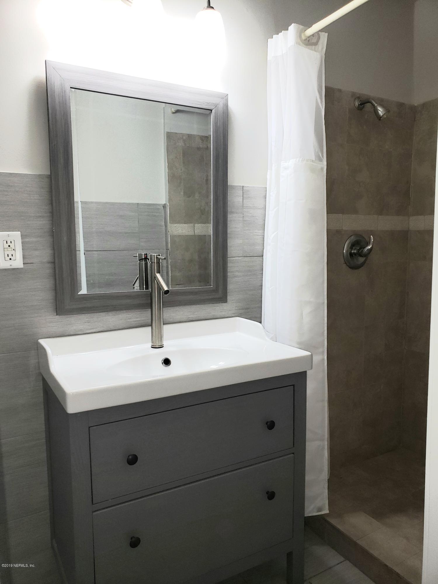 4030 Springwood Road Jacksonville, FL 32207 - Photo 11 of 19 a bathroom with a sink and mirror