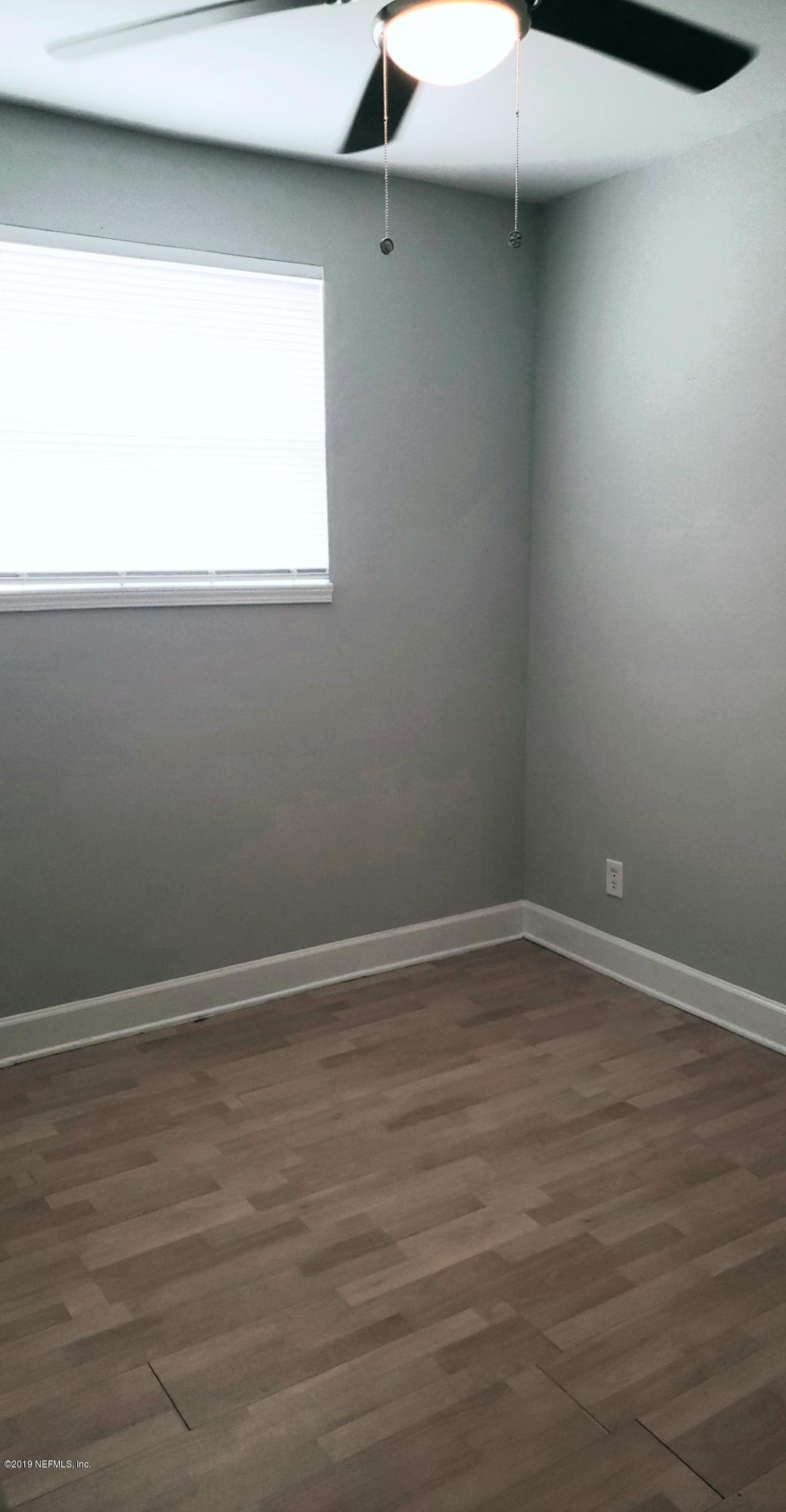 4030 Springwood Road Jacksonville, FL 32207 - Photo 12 of 19 a view of a small space with wooden floor and a window
