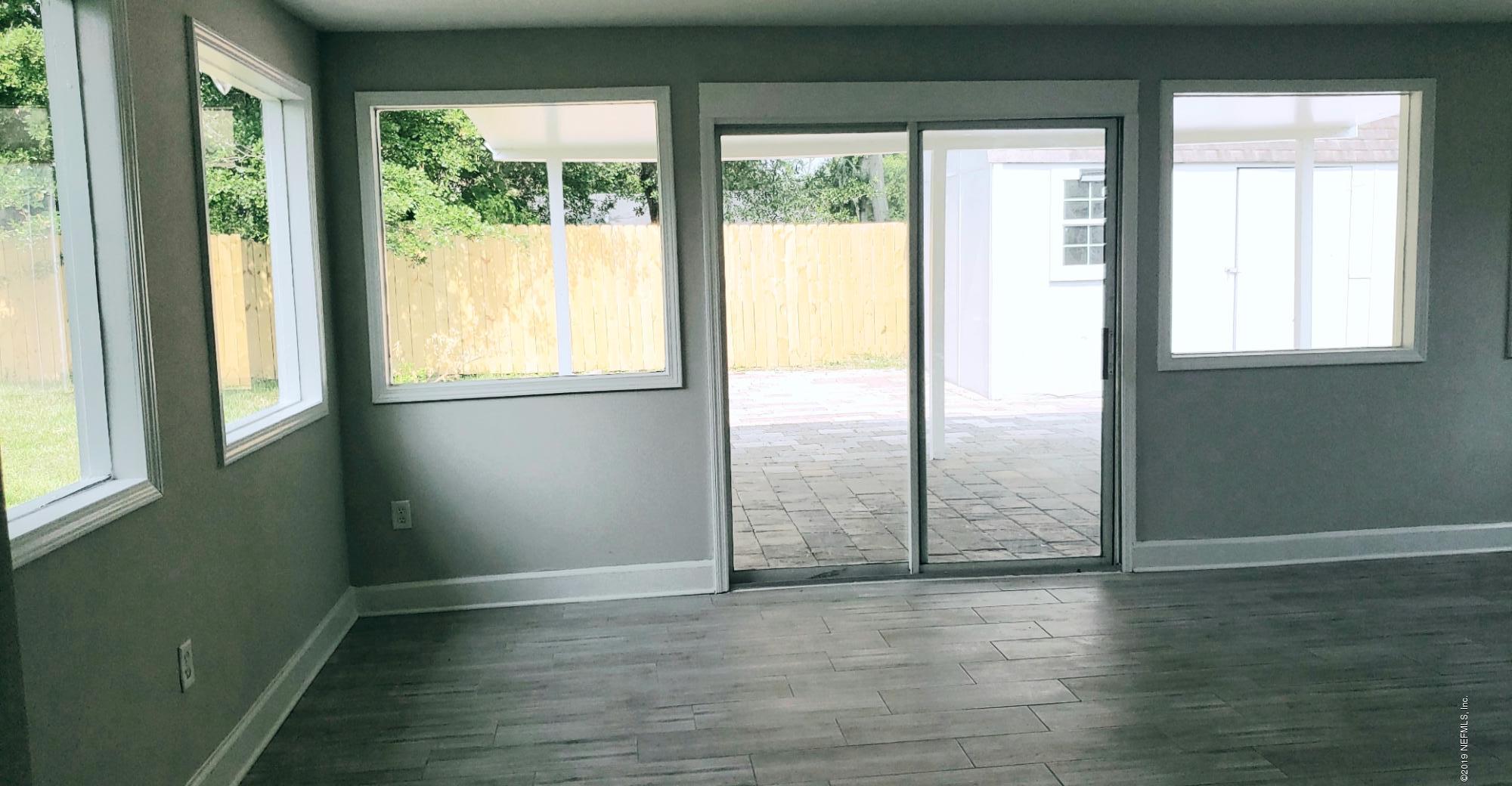 4030 Springwood Road Jacksonville, FL 32207 - Photo 14 of 19 a view of an empty room with wooden floor and a window
