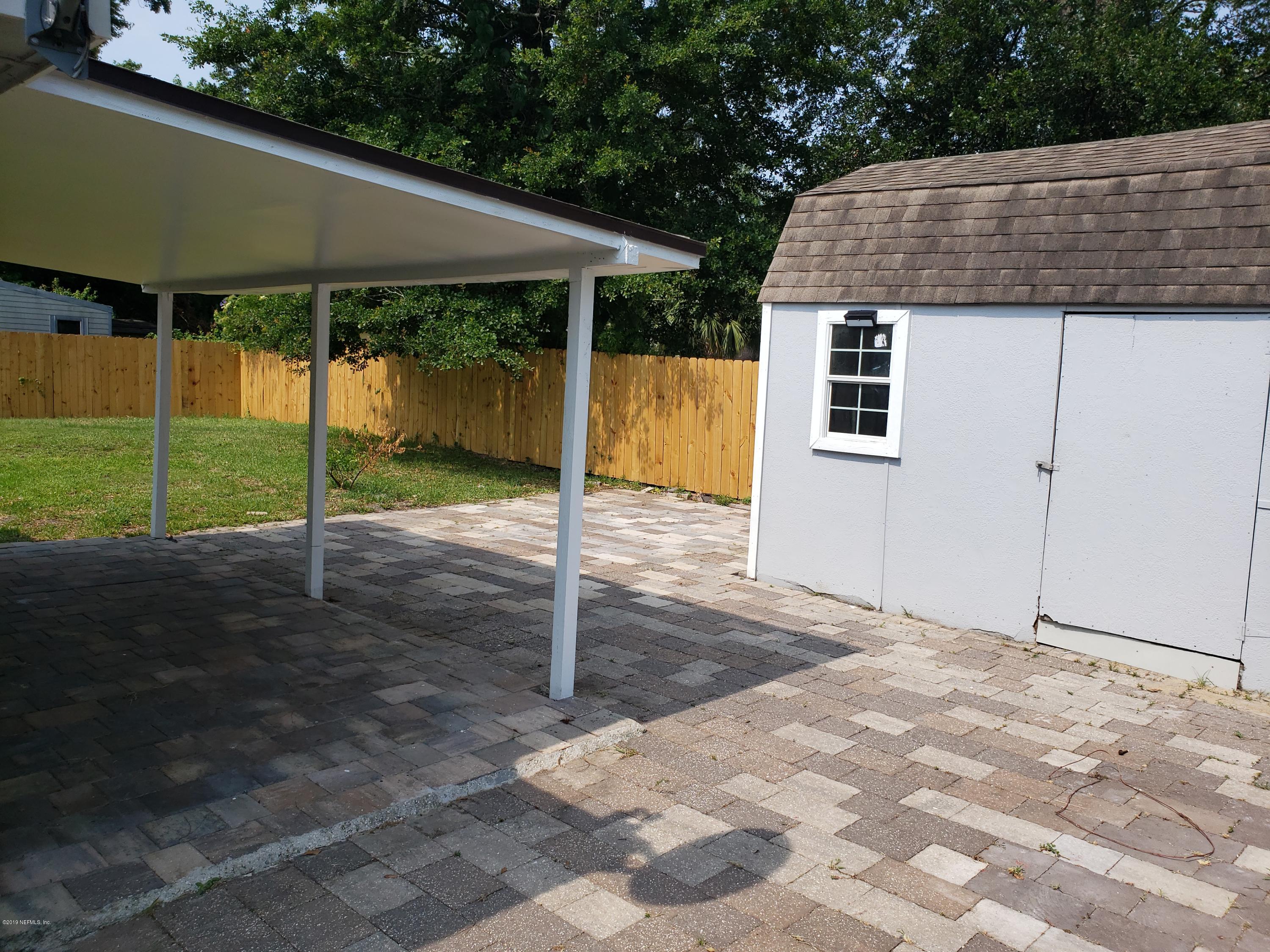 4030 Springwood Road Jacksonville, FL 32207 - Photo 16 of 19 a backyard of a house with plants and outdoor seating