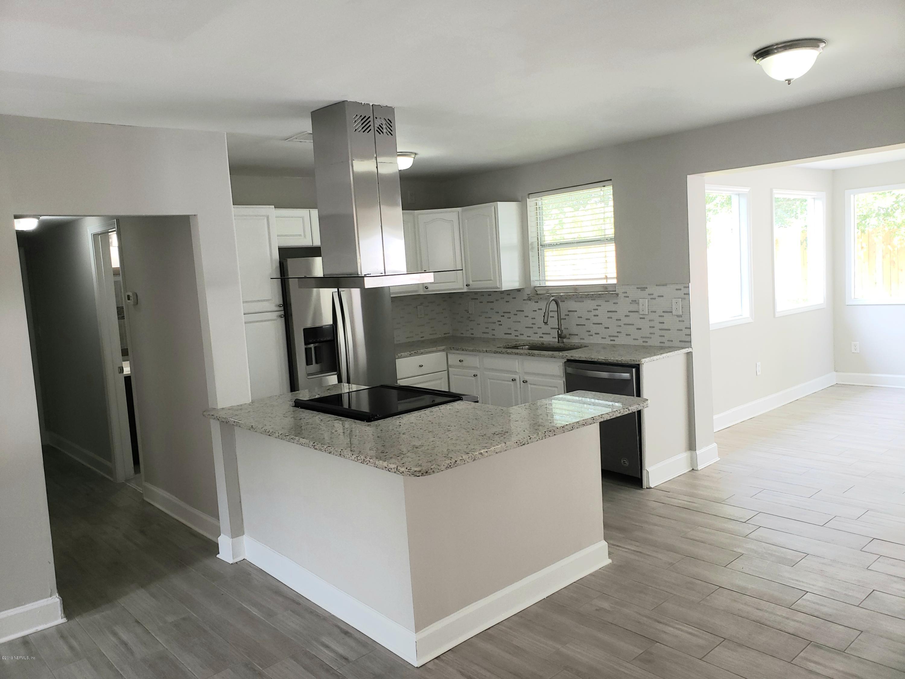4030 Springwood Road Jacksonville, FL 32207 - Photo 3 of 19 a kitchen with stainless steel appliances granite countertop a sink stove and refrigerator