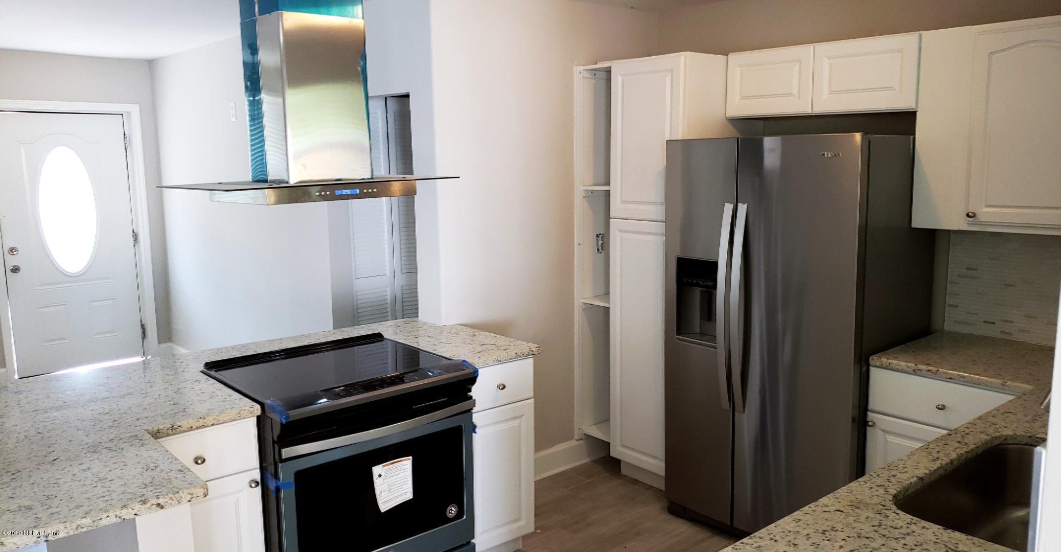 4030 Springwood Road Jacksonville, FL 32207 - Photo 4 of 19 a kitchen with a refrigerator and a stove