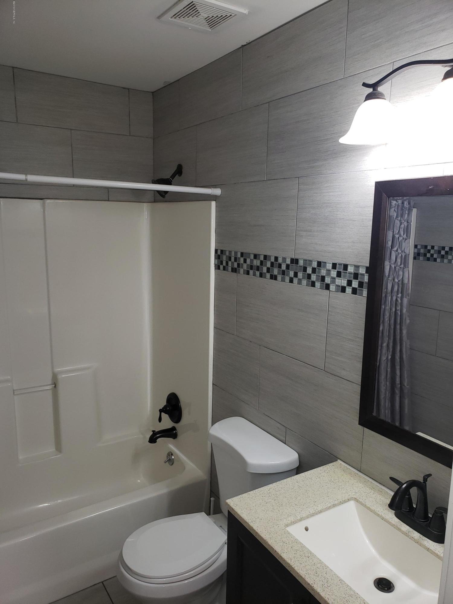 4030 Springwood Road Jacksonville, FL 32207 - Photo 7 of 19 a bathroom with a sink a toilet and shower