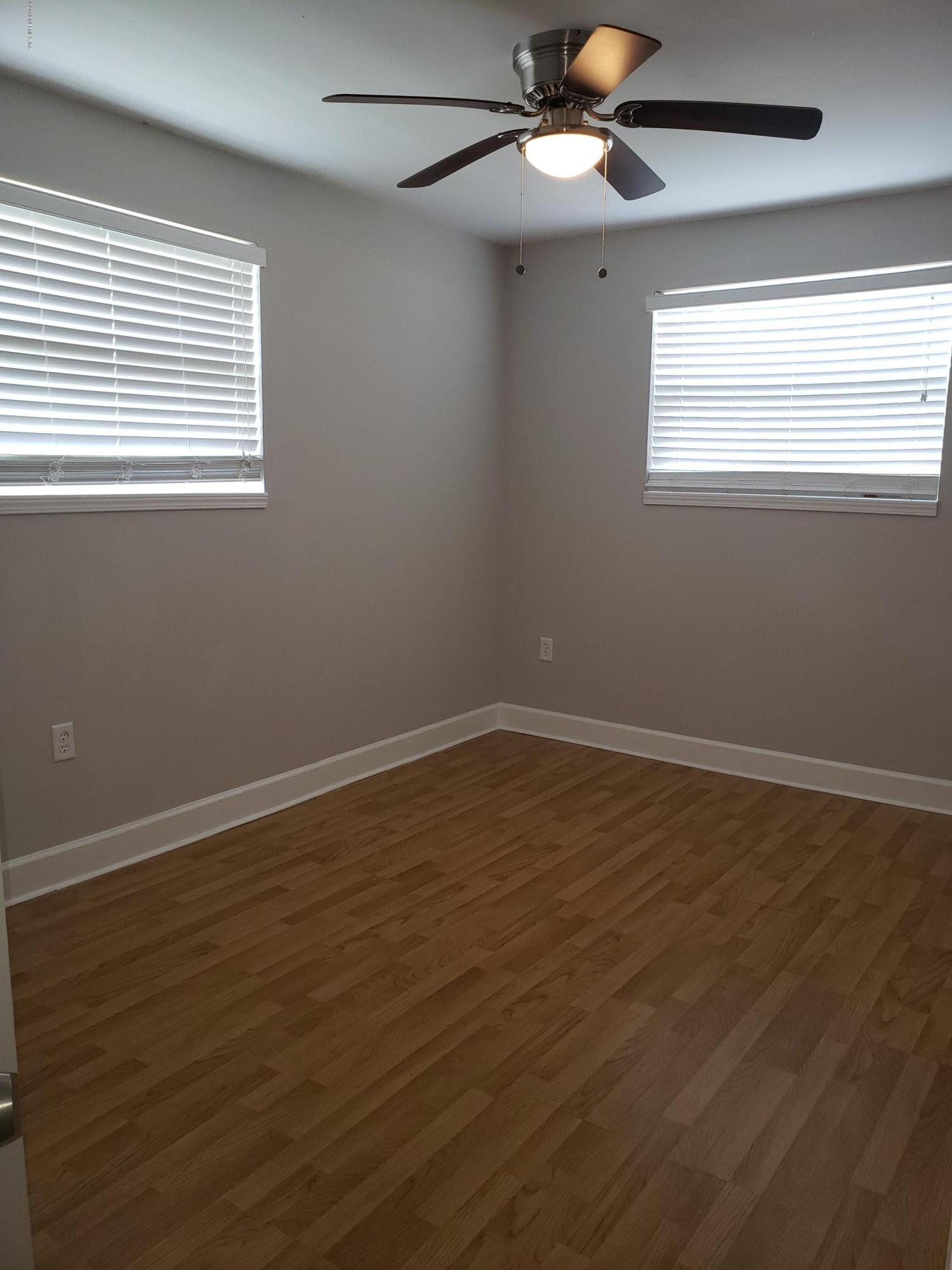 4030 Springwood Road Jacksonville, FL 32207 - Photo 8 of 19 a view of an empty room with wooden floor and a window