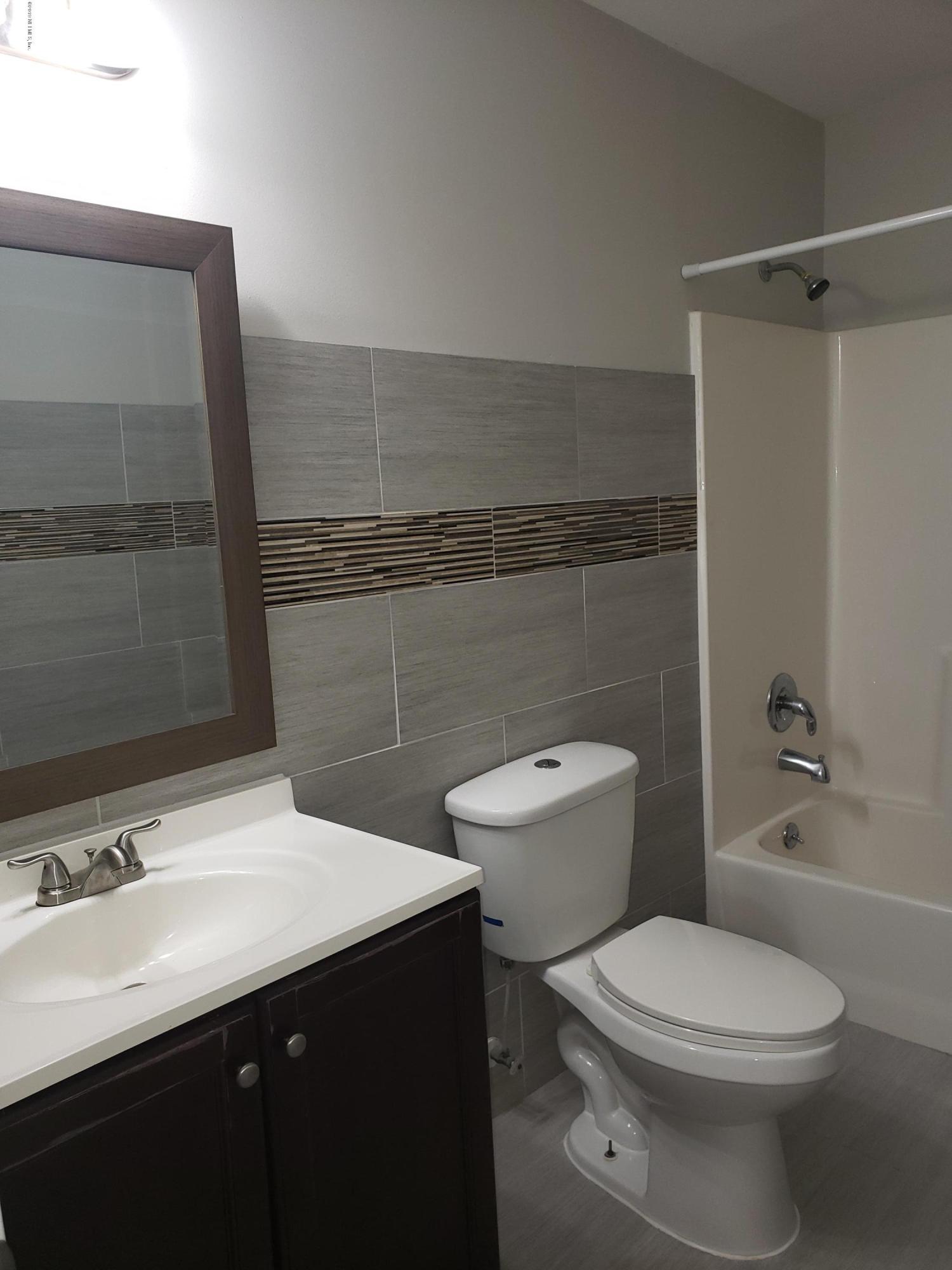 4030 Springwood Road Jacksonville, FL 32207 - Photo 9 of 19 a bathroom with a sink a toilet and shower