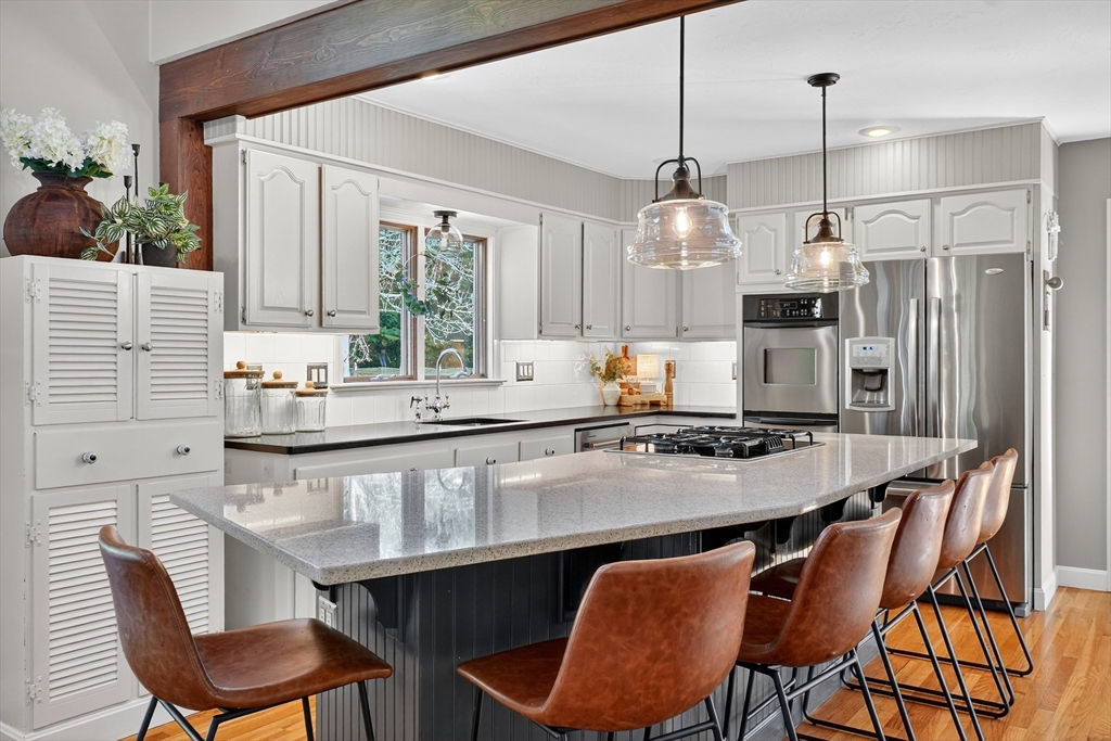 191 Hathaway Road Acushnet, MA 02743 - Photo 11 of 42 a kitchen with a table chairs sink and cabinets