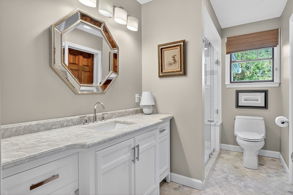 191 Hathaway Road Acushnet, MA 02743 - Photo 27 of 42 a bathroom with a toilet a sink a mirror and a window