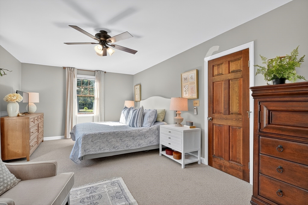 191 Hathaway Road Acushnet, MA 02743 - Photo 29 of 42 a bedroom with a bed and a chandelier