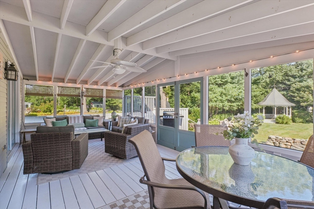 191 Hathaway Road Acushnet, MA 02743 - Photo 33 of 42 a view of a dining room with furniture large windows and wooden floor
