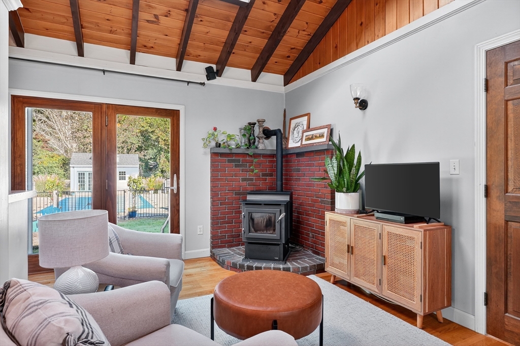 191 Hathaway Road Acushnet, MA 02743 - Photo 7 of 42 a living room with furniture a flat screen tv and a fireplace