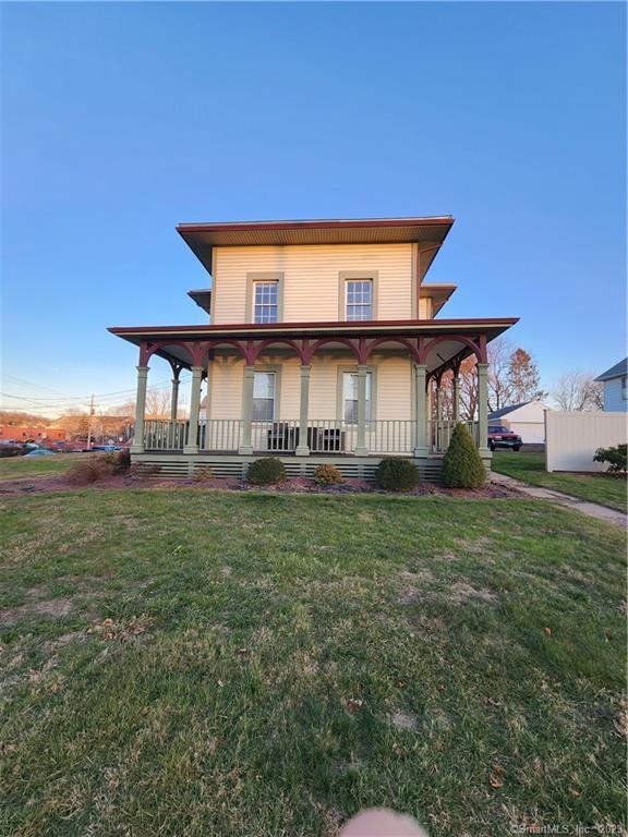 a front view of house with yard and seating space