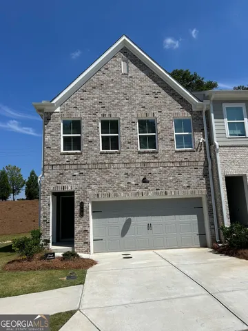 a front view of a house with yard