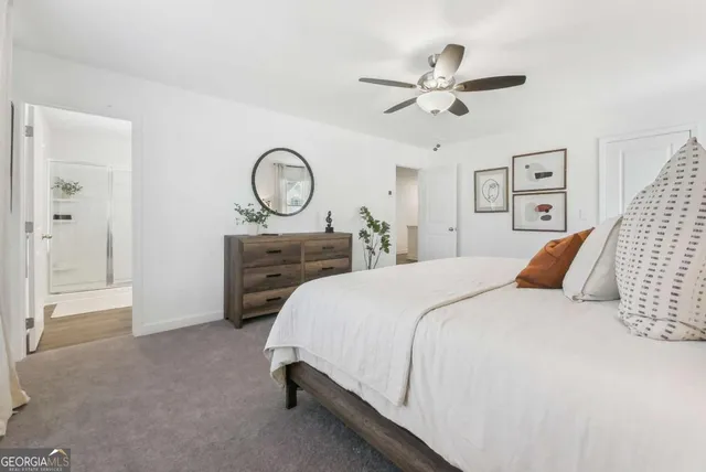 a bedroom with a bed and ceiling fan