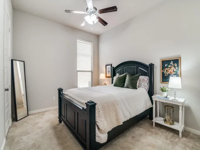 a bedroom with a bed and a table