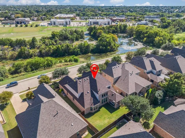 an aerial view of residential houses with outdoor space and river view