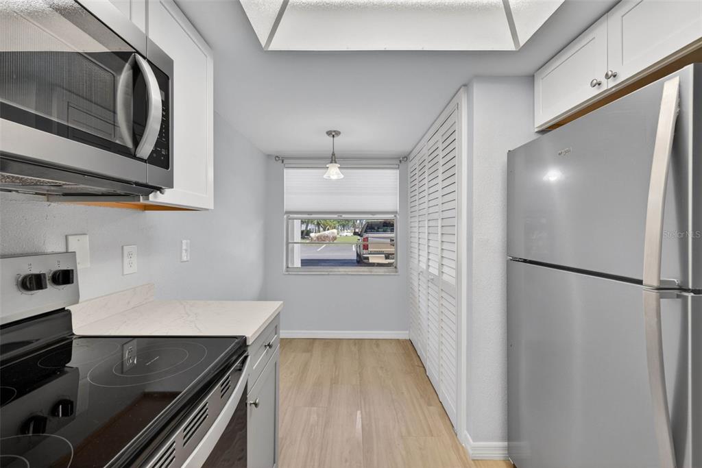 5197 Silent Loop, Unit 124 New Port Richey, FL 34652 - Photo 12 of 55 a kitchen with a refrigerator and a sink