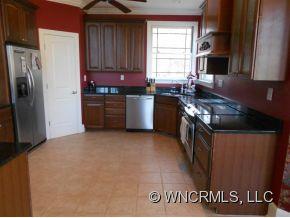 990 Oak Springs Road Rutherfordton, NC 28139 - Photo 7 of 14 a kitchen with stainless steel appliances granite countertop a stove a sink and a refrigerator
