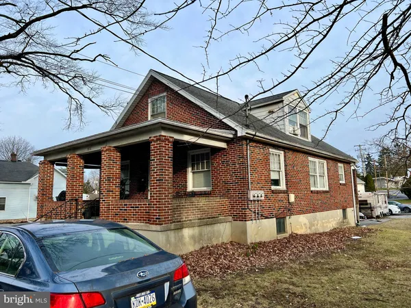 a front view of a house with parking area