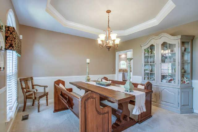 Elegant dining with chair rail and octagonal tray ceiling