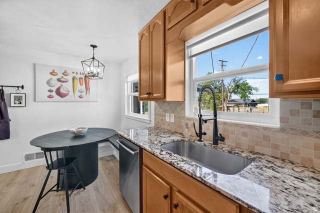 66 South 425 West Bountiful, UT 84010 - Photo 8 of 25 Kitchen featuring light wood-finish cabinetry and a stainless steel sink with a matte black faucet