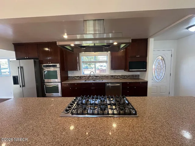 a kitchen with a refrigerator and a sink