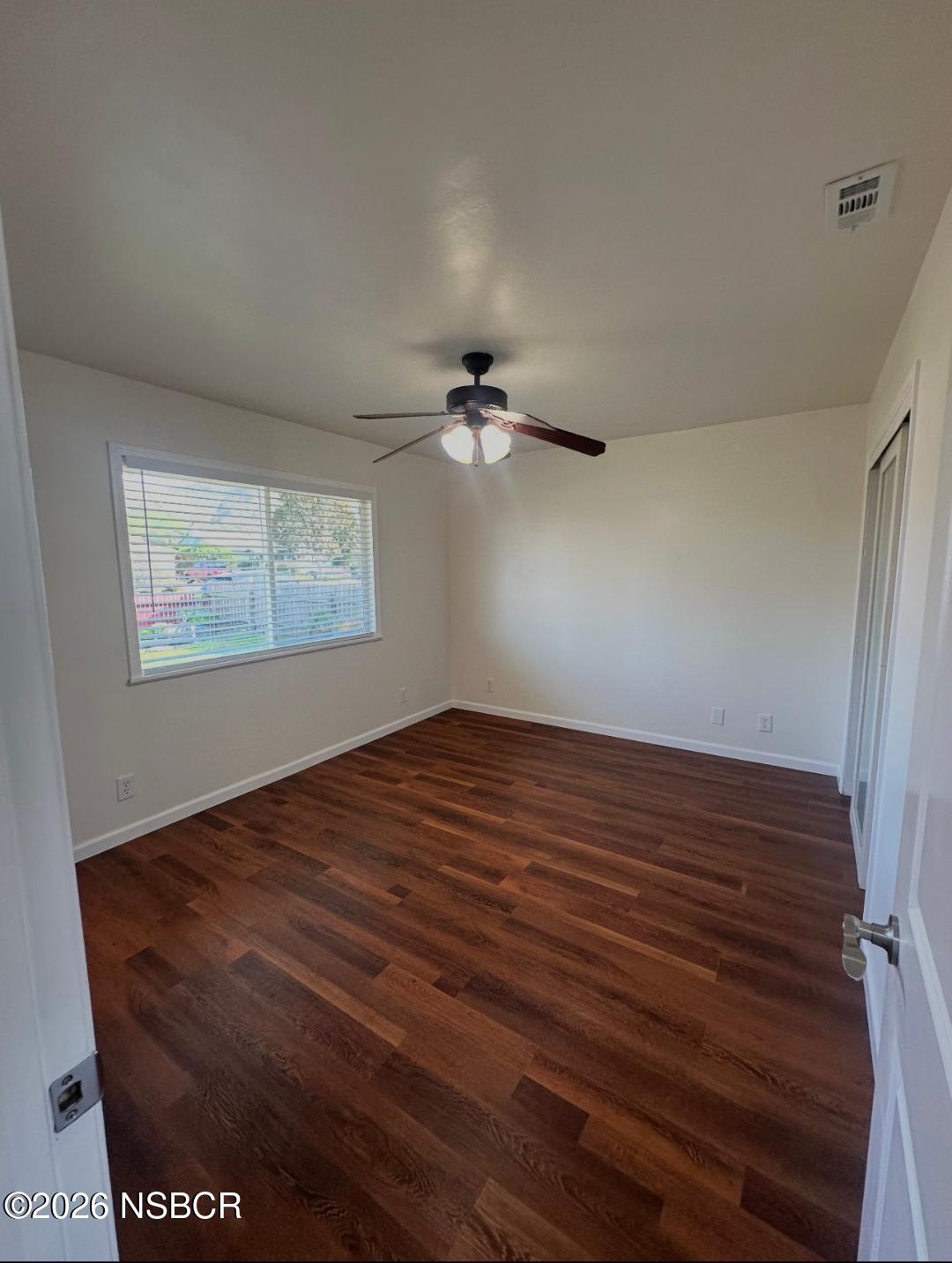 319 South B Street Lompoc, CA 93436 - Photo 17 of 19 a view of a room with wooden floor and a ceiling fan