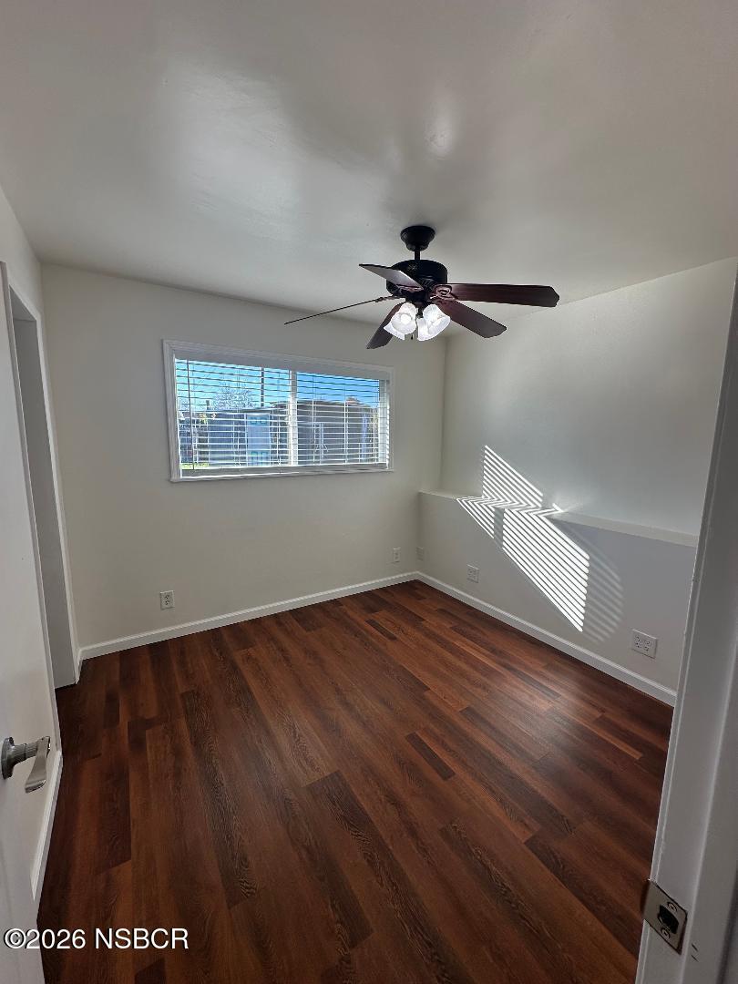 319 South B Street Lompoc, CA 93436 - Photo 18 of 19 a view of an empty room with wooden floor and a window