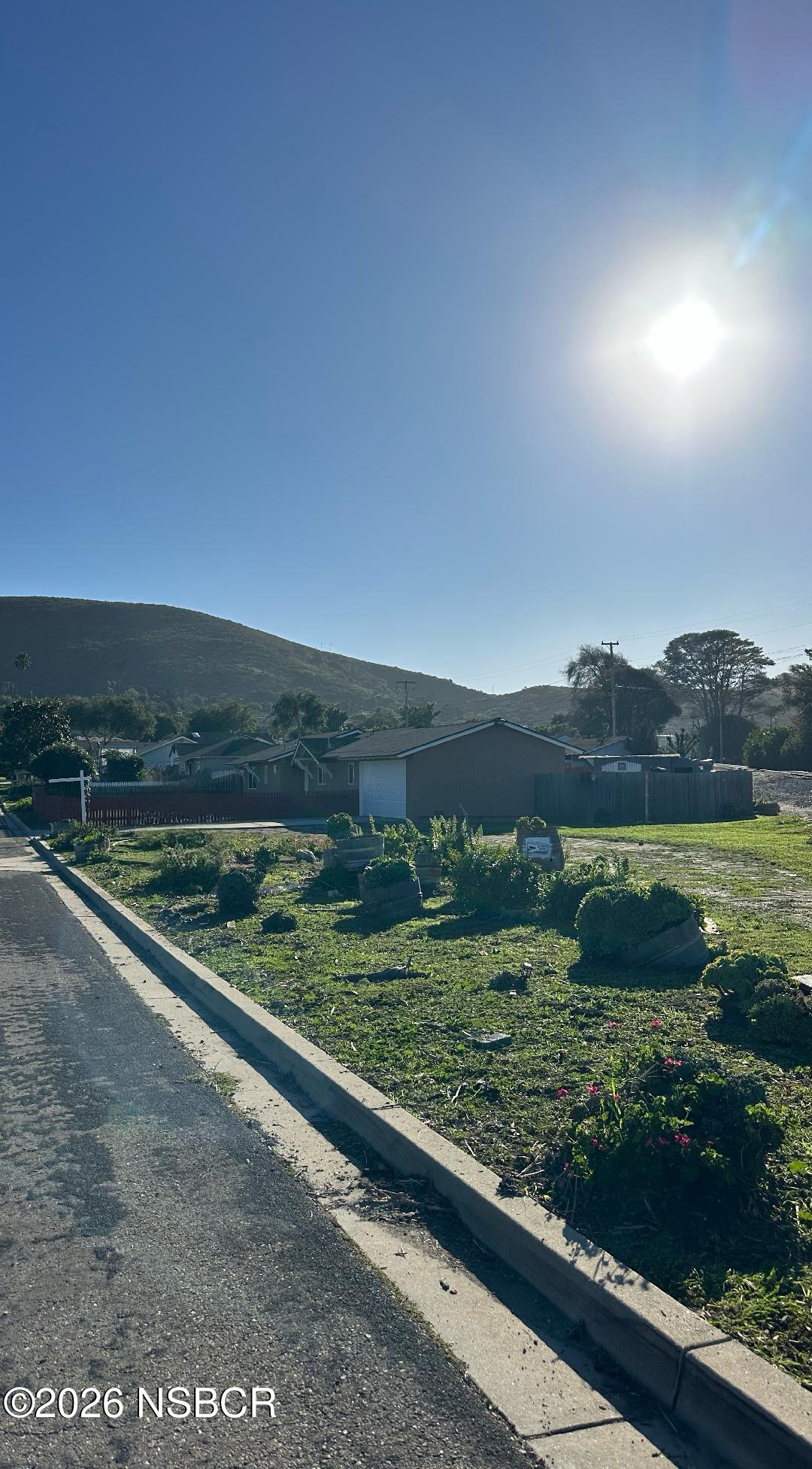 319 South B Street Lompoc, CA 93436 - Photo 3 of 19 a view of a yard with wooden fence