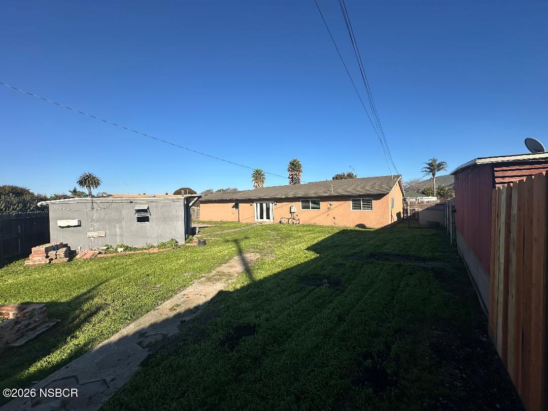319 South B Street Lompoc, CA 93436 - Photo 6 of 19 a view of a house with a yard