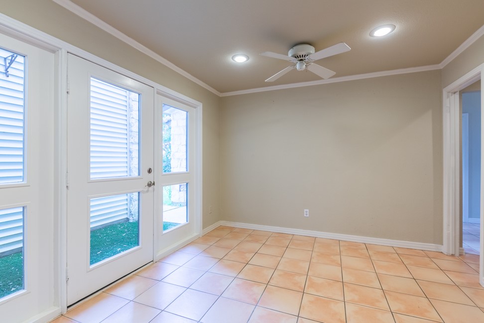 10907 Legends Lane Austin, TX 78747 - Photo 13 of 35 Spare room with ornamental molding, light tile patterned floors, a ceiling fan, and recessed lighting