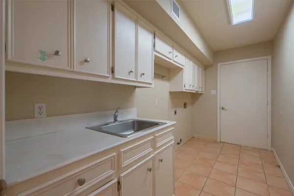 a kitchen with a sink and cabinets