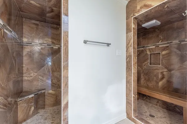 a bathroom with a glass shower door