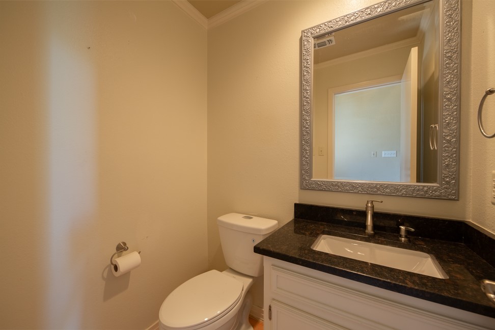 10907 Legends Lane Austin, TX 78747 - Photo 29 of 35 Half bathroom with crown molding and vanity