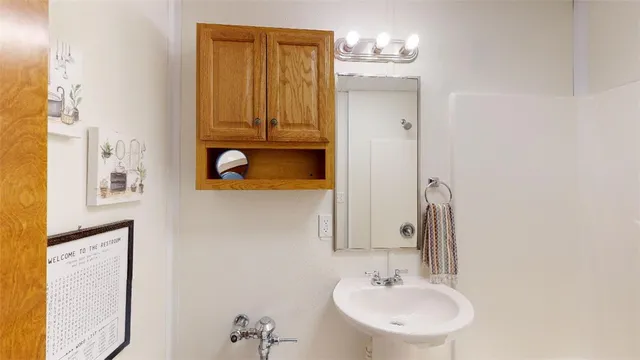 a bathroom with a sink a mirror and a toilet
