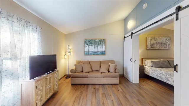 a living room with furniture and a walk in closet