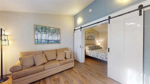 a living room with furniture and a wooden floor