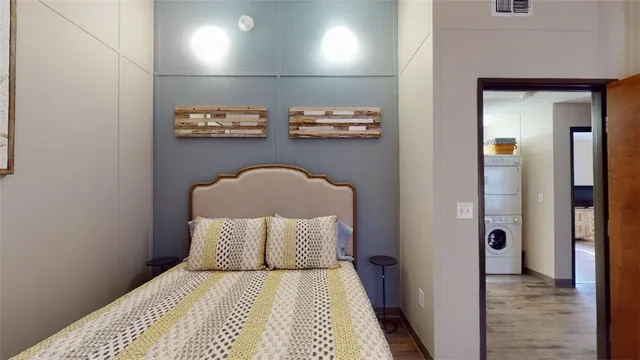 a bedroom with a bed and a lamp on table