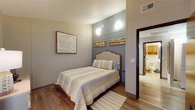 a bedroom with a bed and a lamp