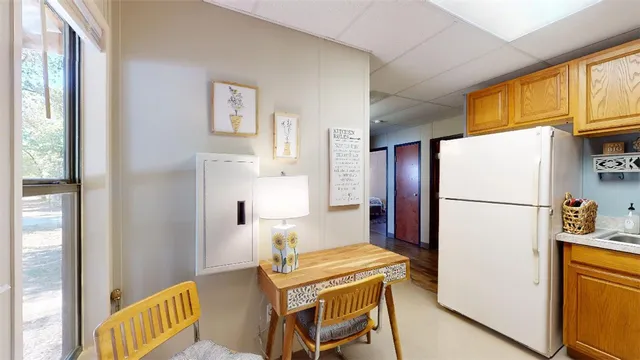 a kitchen with stainless steel appliances a refrigerator a sink and a cabinets