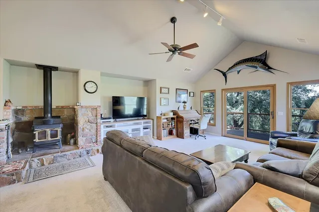 a living room with furniture a rug and kitchen view